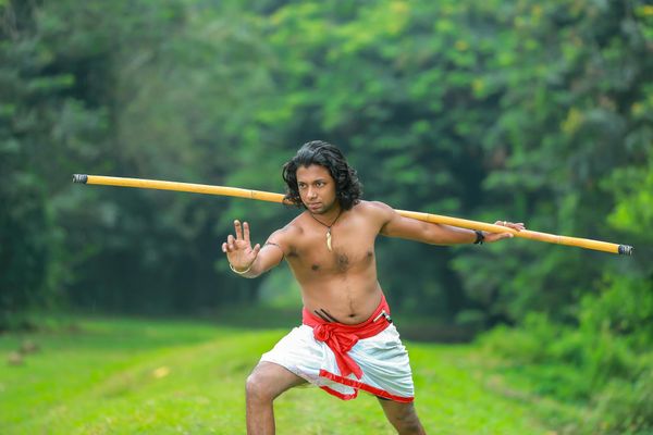 Person performing a controlled movement in a calm, focused environment.